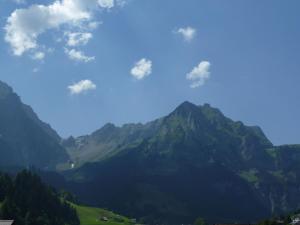 a view of a mountain range with a blue sky at Apartment Birkenstrasse 52 by Interhome in Engelberg