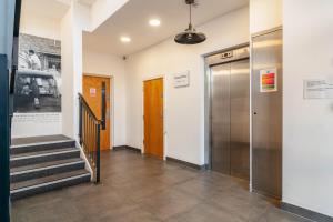 a hallway with two elevators and a door at Modern Double Room - Haywards Heath in Haywards Heath