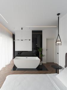 a bedroom with a white tub in a room at Evo Residence Panoramic in Cluj-Napoca
