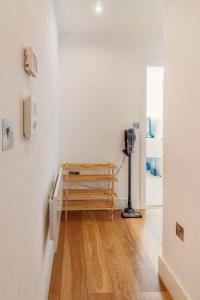 a room with white walls and a wooden table at Modern Double Room - Haywards Heath in Haywards Heath