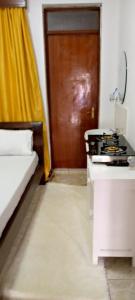 a room with a kitchen with a stove and a door at Studio Apartment in Nairobi in Nairobi