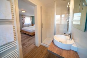 a bathroom with a sink and a shower at Landgasthof Hanselewirt in Schwangau