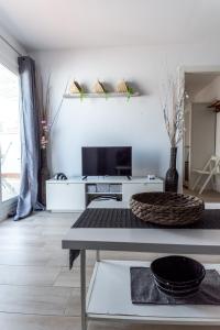 a living room with a tv and a table at Amadeu 1, Calella in Calella