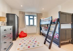 a childs bedroom with a bunk bed and a rug at Castle Keep in Southwold