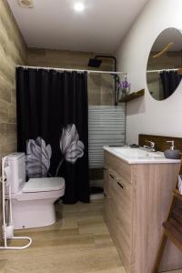 a bathroom with a black shower curtain and a toilet at Amadeu 1, Calella in Calella