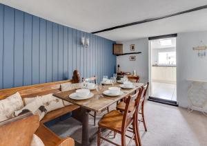 a dining room with a wooden table and chairs at Church Cottage in Wangford
