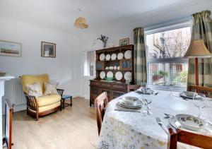 a dining room with a table and a chair at Clyde Cottage in Saxmundham