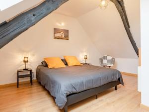 a bedroom with a bed in a attic at Holiday Home La petite maison by Interhome in Gouville-sur-Mer