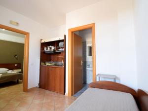 a bedroom with a bed and a door leading to a bathroom at Apartment L'Ancora-2 by Interhome in Porto Empedocle