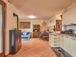 a kitchen with a refrigerator and a living room at Holiday Home Aaron by Interhome in Tremosine Sul Garda
