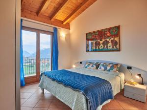 a bedroom with a bed and a large window at Holiday Home Aaron by Interhome in Tremosine Sul Garda