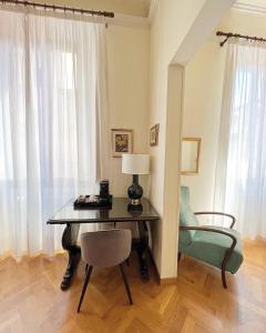uma secretária com um candeeiro e uma cadeira num quarto em Cimabue 9 em Florença