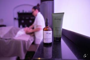 a bottle of moisturizers on a table in a hospital room at Georges Blanc Parc & Spa - Relais & Chateaux in Vonnas