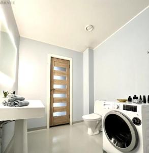 a bathroom with a washing machine and a toilet at Villa in Tallinn