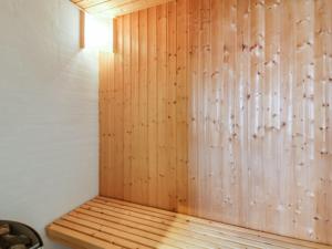 una sauna con una pared de madera en una habitación en Holiday Home Segelferd - 650m from the sea in NW Jutland by Interhome, en Løkken