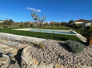 a swimming pool in the middle of a yard at L'Escale au Portugal Villa-B&B-Spa in Ataíja de Baixo