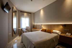 Katil atau katil-katil dalam bilik di Hotel Barrameda