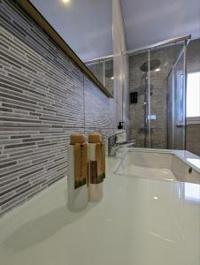 a white bathroom with a tub and a sink at m-odern in Seville