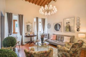 een woonkamer met een bank, stoelen en een kroonluchter bij SANGALLO Suite-Hosted by Sweetstay in Florence