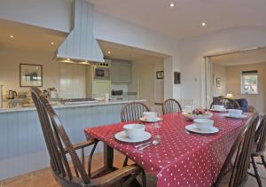 a table with a red and white polka dot table cloth at Easter Cottage in Westleton