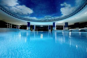 a swimming pool at night with the stars on the ceiling at The Celtic Manor Resort in Newport