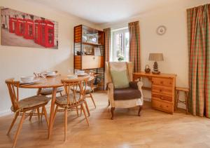 a dining room with a table and chairs at Farriers in Wangford