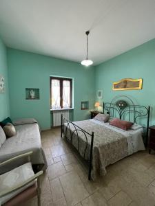 a bedroom with two beds and blue walls at Il Grande Ulivo in Selva di Fasano