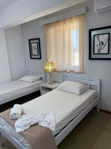 a bedroom with two beds and a window at Popi Studios in Kos Town