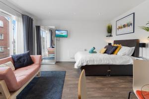 a living room with a bed and a couch at Exeter City Centre Apartments Eden Apartment in Exeter