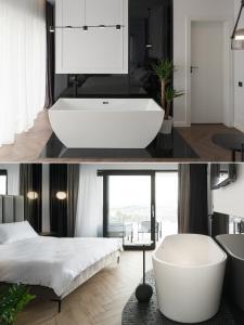 a bathroom with a white bath tub and a bed at Evo Residence Panoramic in Cluj-Napoca