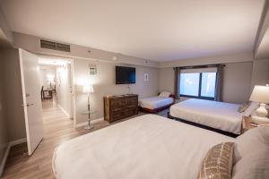 a hotel room with two beds and a flat screen tv at Stay Together Suites on The Strip - 2 Bedroom Suite 976 in Las Vegas +58 photos