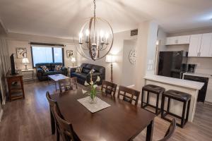 a dining room and living room with a table and chairs at Stay Together Suites on The Strip - 2 Bedroom Suite 976 in Las Vegas