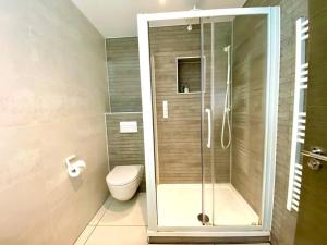 a bathroom with a shower and a toilet at Stunning 3 bedroom Penthouse Apartment - Free Parking & WiFi - 1 Minute walk to Poole Quay - Great Location - Free Parking - Fast WiFi - Smart TV - Newly decorated - sleeps up to 6! Close to Poole & Bournemouth & Sandbanks in Poole