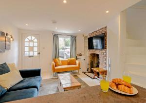 a living room with a couch and a fireplace at Harbour Cottage - Ramsgate in Ramsgate