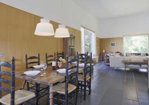 a dining room with a long table and chairs at Glenview in Bramfield