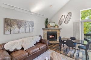 a living room with a couch and a fireplace at Ski In out Remodeled Luxury Condo in Telluride