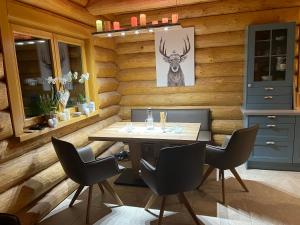 a dining room with a table and chairs at Chalet Hochrindl 2 B in Hochrindl