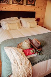 a bed with hats and books on top of it at Cabanas de Melides in Melides