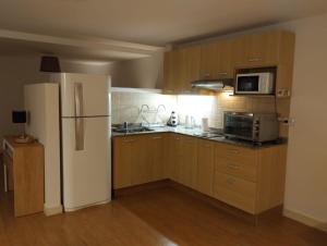 a kitchen with wooden cabinets and a white refrigerator at Vista DAT in San Carlos de Bariloche +8 photos