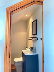 a bathroom with a sink and a toilet at Mini-studio by HNFC Stays in South Shields