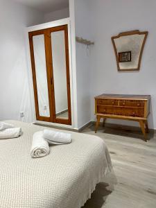 a bedroom with a bed and a dresser and a mirror at Loft Time - Somhome in Peniscola