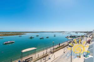 a view of a river with boats in the water at Cabanas Ria Sea View By Algartur in Cabanas de Tavira
