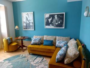 アラッシオにあるGrand Hotel Alassio Beach & Spa Resort - The Leading Hotels of the Worldの青い壁のリビングルーム(黄色のソファ付)