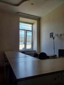 a large desk in an office with a window at A1 Hostel in Lviv