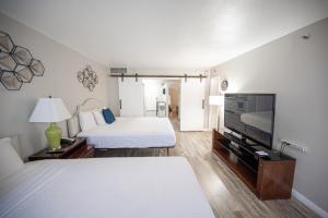 um quarto de hotel com uma cama e uma televisão de ecrã plano em Stay Together Suites on The Strip - 2 Bedroom 1124 em Las Vegas