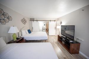 a hotel room with a bed and a flat screen tv at Stay Together Suites on The Strip - 2 Bedroom 1124 in Las Vegas +57 photos