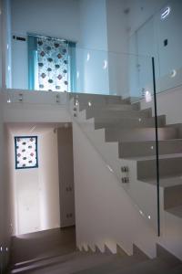 a staircase in a building with a glass wall at LAURIA Luxury Room in Gela