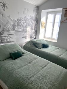 Posteľ alebo postele v izbe v ubytovaní La Maison de Lena 500m de la Plage