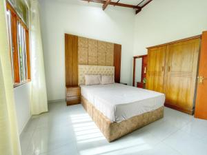 a bedroom with a large bed in a room at Ceylon Serenity Villa in Beruwala