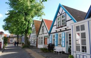 a row of houses with people walking down a street at Birnbom Warnemünde in Warnemünde